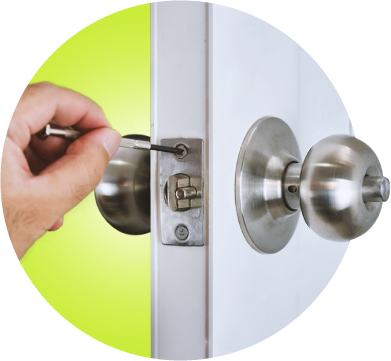 A Technician Uses A Screwdriver To Install A Doorknob Lock On A White Door.