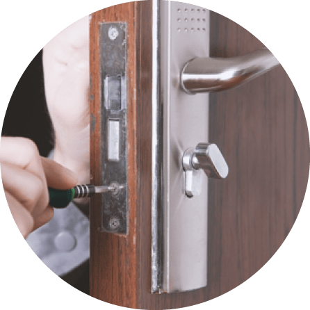An Equipped Locksmith Technician Is Installing A Deadbolt Single Cylinder With Passage Lever On The Door Of A Business.