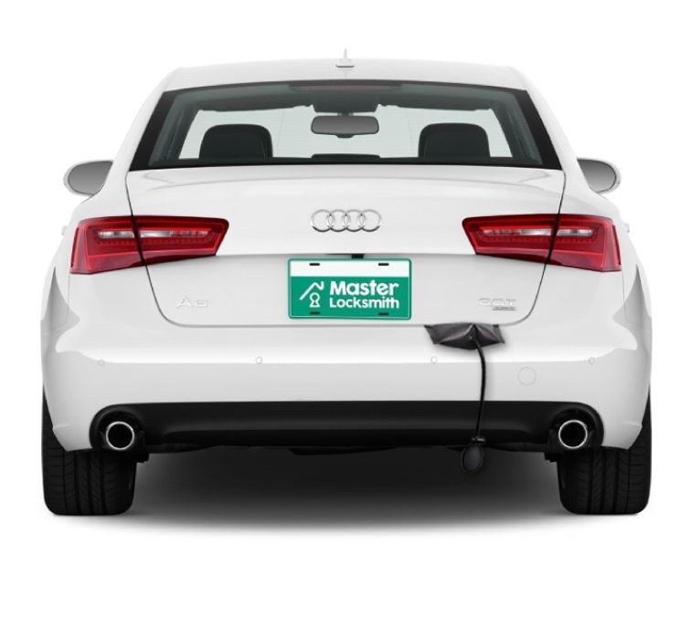 Back View Of An Audi Showcasing A 'Master Locksmith' Branded License Plate.