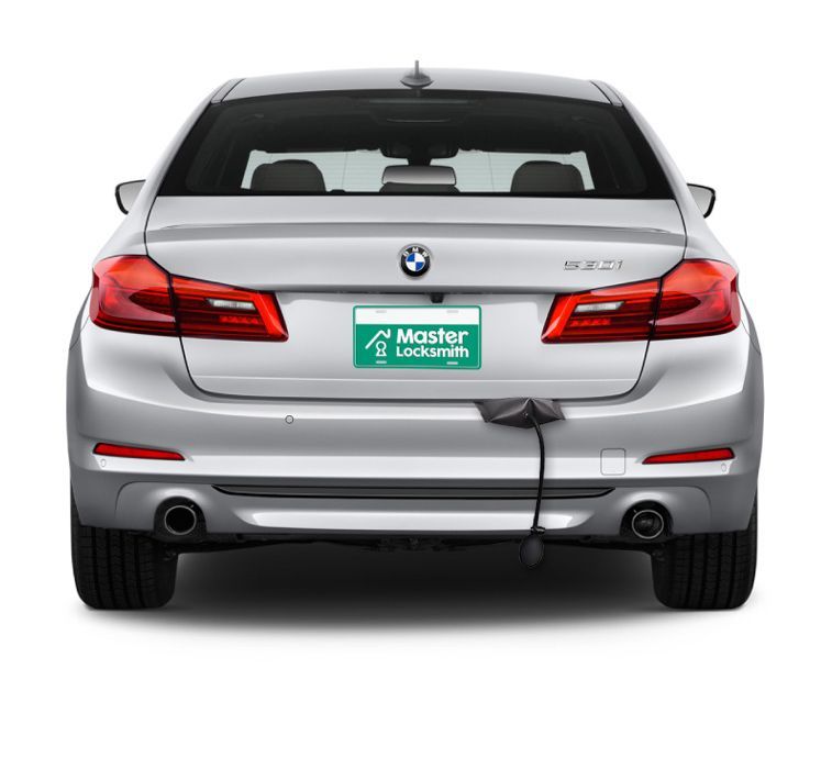 Back View Of A BMW Showcasing A 'Master Locksmith' Branded License Plate.
