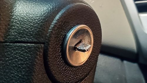 A Broken Car Key On Car's Ignition.