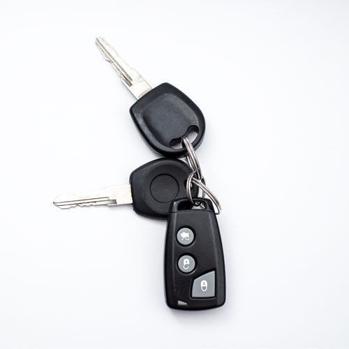 A Car Key With Its Duplicate Made By An Expert Locksmith.
