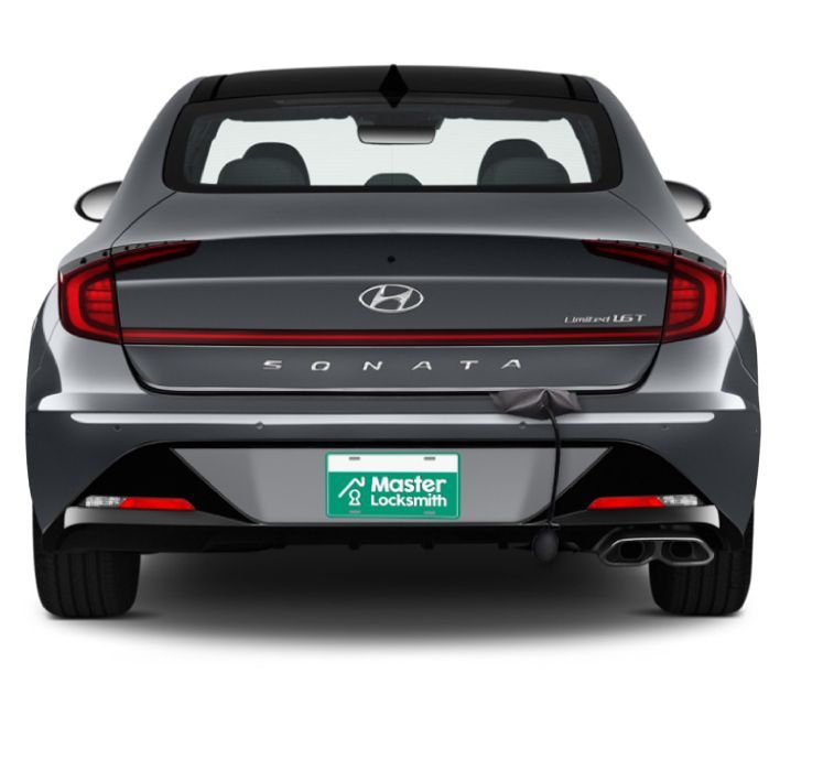 Back View Of A Hyundai Showcasing A 'Master Locksmith' Branded License Plate.