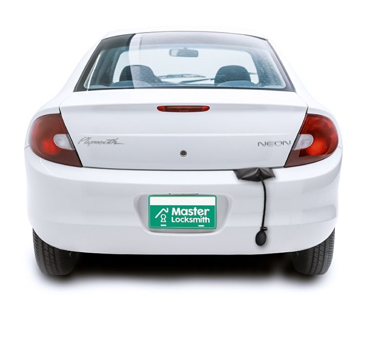 Back View Of A Plymouth Showcasing A 'Master Locksmith' Branded License Plate.