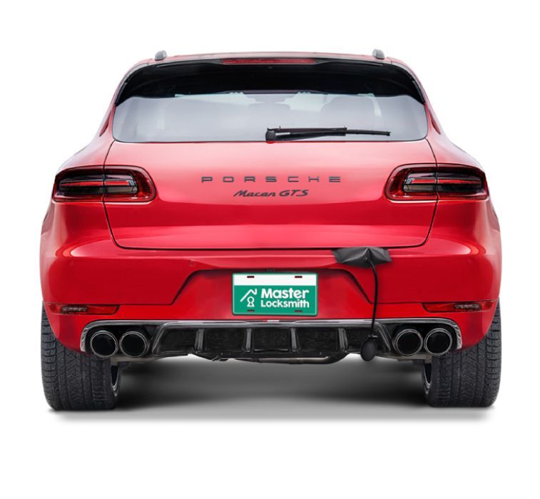 Back View Of A Porsche Showcasing A 'Master Locksmith' Branded License Plate.