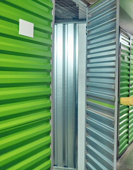A Storage Unit With Green Walls And Open Door.