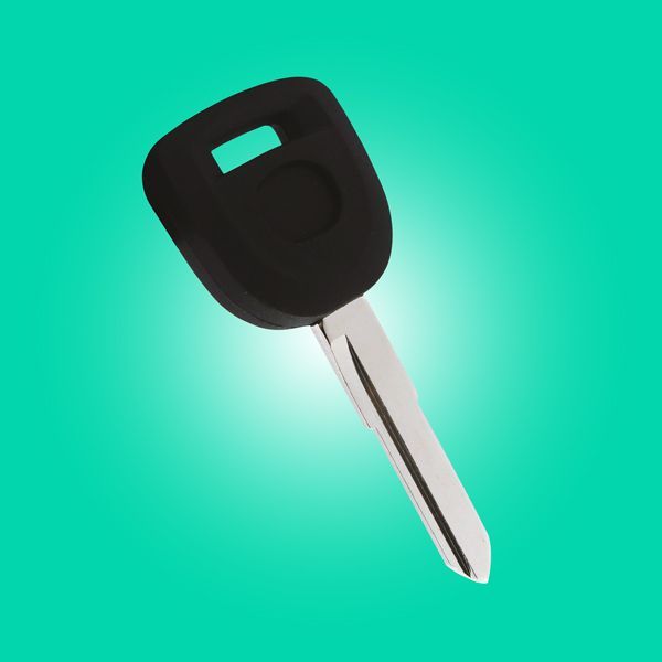 A Close Up Of A Transponder Car Key On A Green Background.
