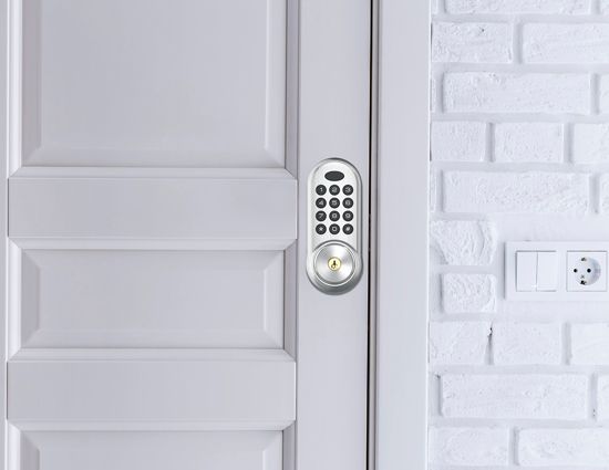 A White Door With A Smart Lock On It Next To A White Brick Wall.