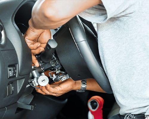 An Automotive Technician Is Replacing The Ignition Lock Of A Vehicle.