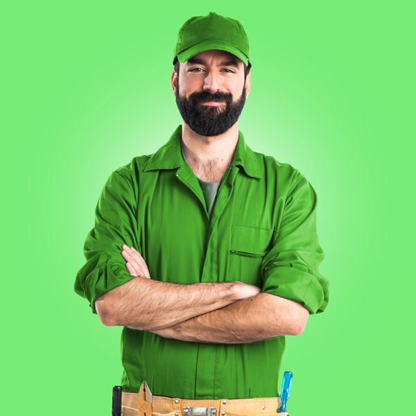 A Man With A Beard Is Wearing A Green Uniform And A Green Hat.