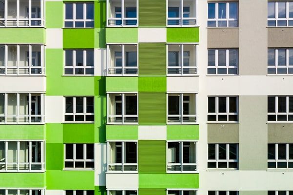 Part Of The Facade With Windows Of A New House With Green-White Walls.