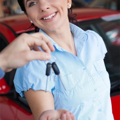 A Smiling Client Receives A New Set Of Car Keys From A Technician.