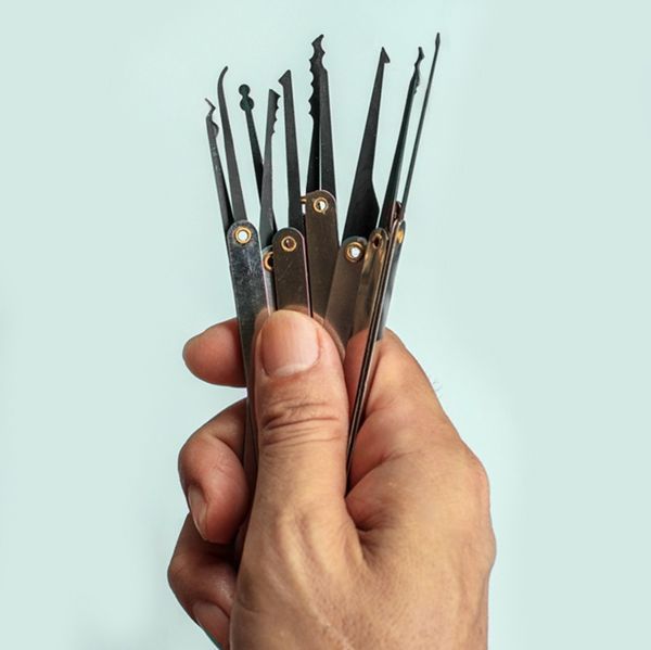A Locksmith Expert Holds Several Lock Picks In His Hand.