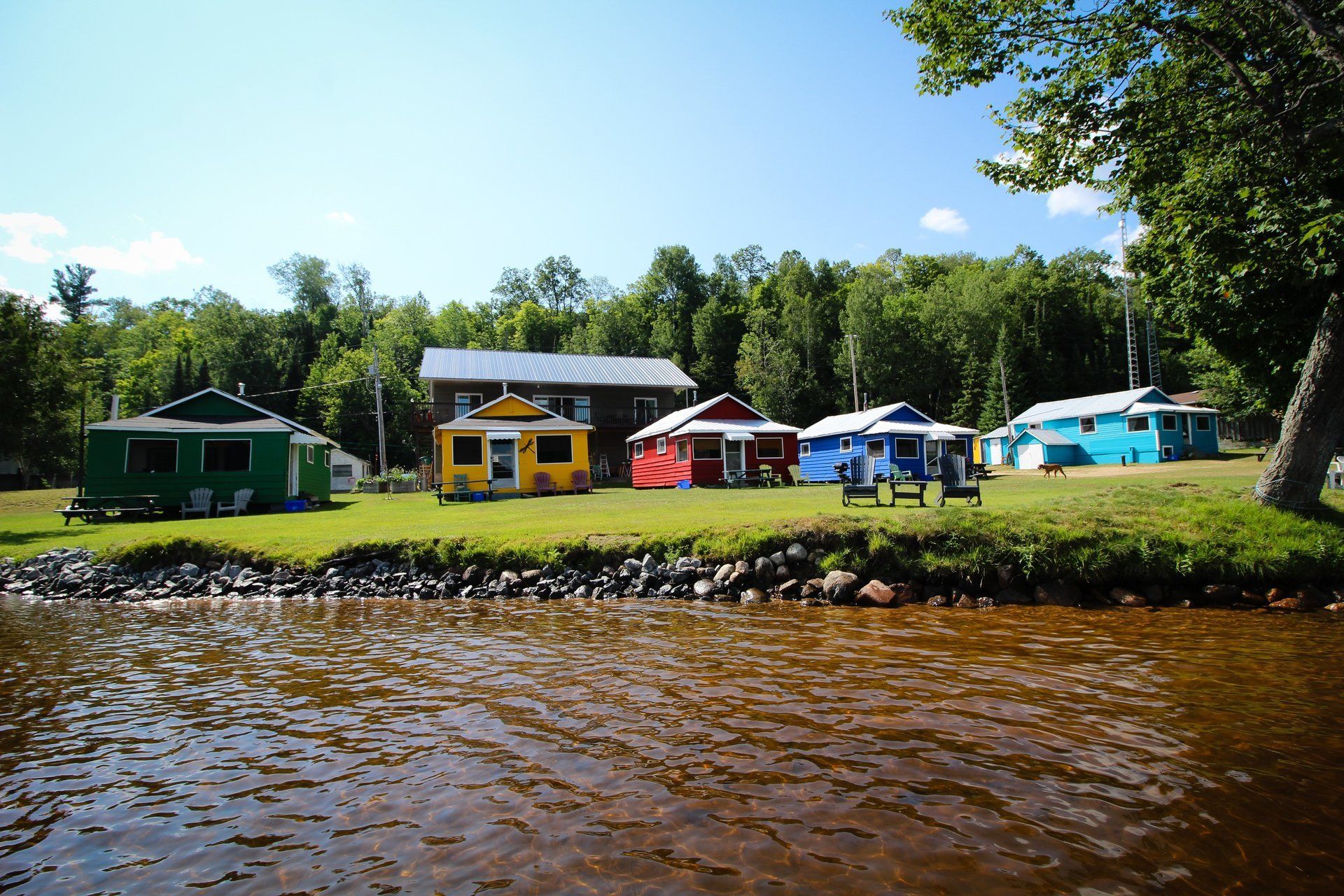 A row of colorful houses sit next to a body of water