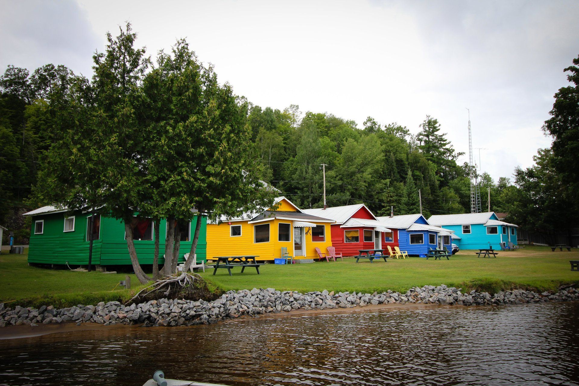 A row of colorful houses sit next to a body of water