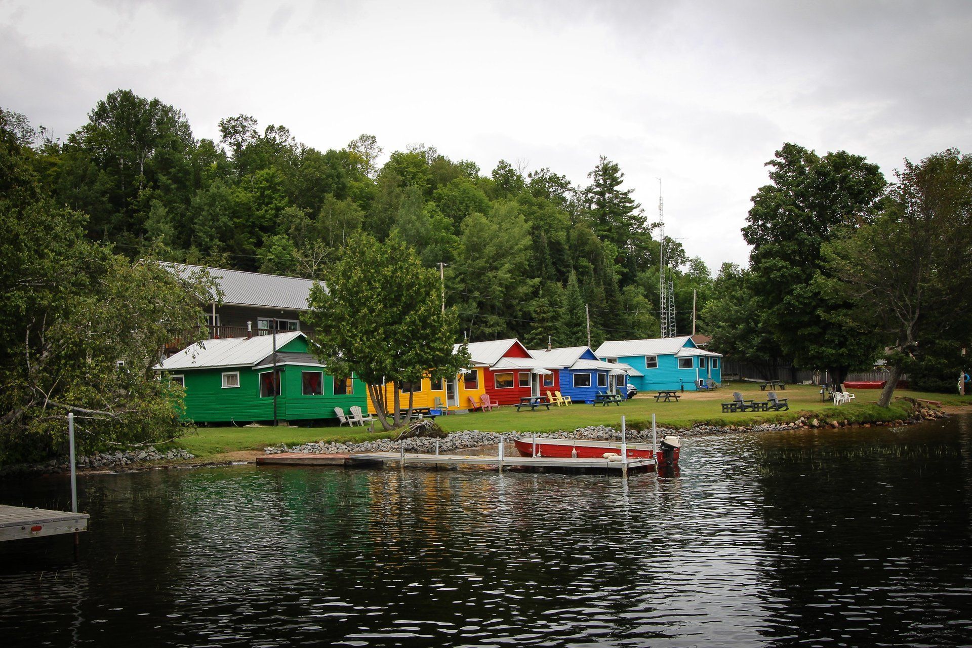 A row of colorful houses sit on the shore of a lake