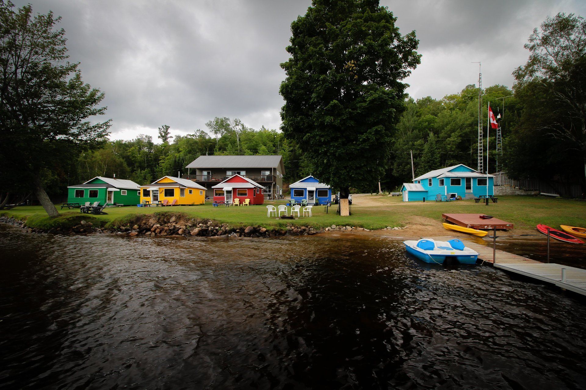 A row of colorful houses sit next to a body of water
