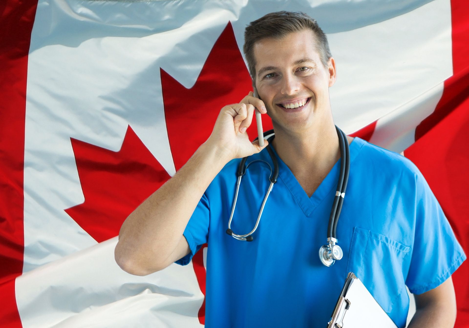 a man with a stethoscope around his neck is talking on a cell phone in front of a canadian flag