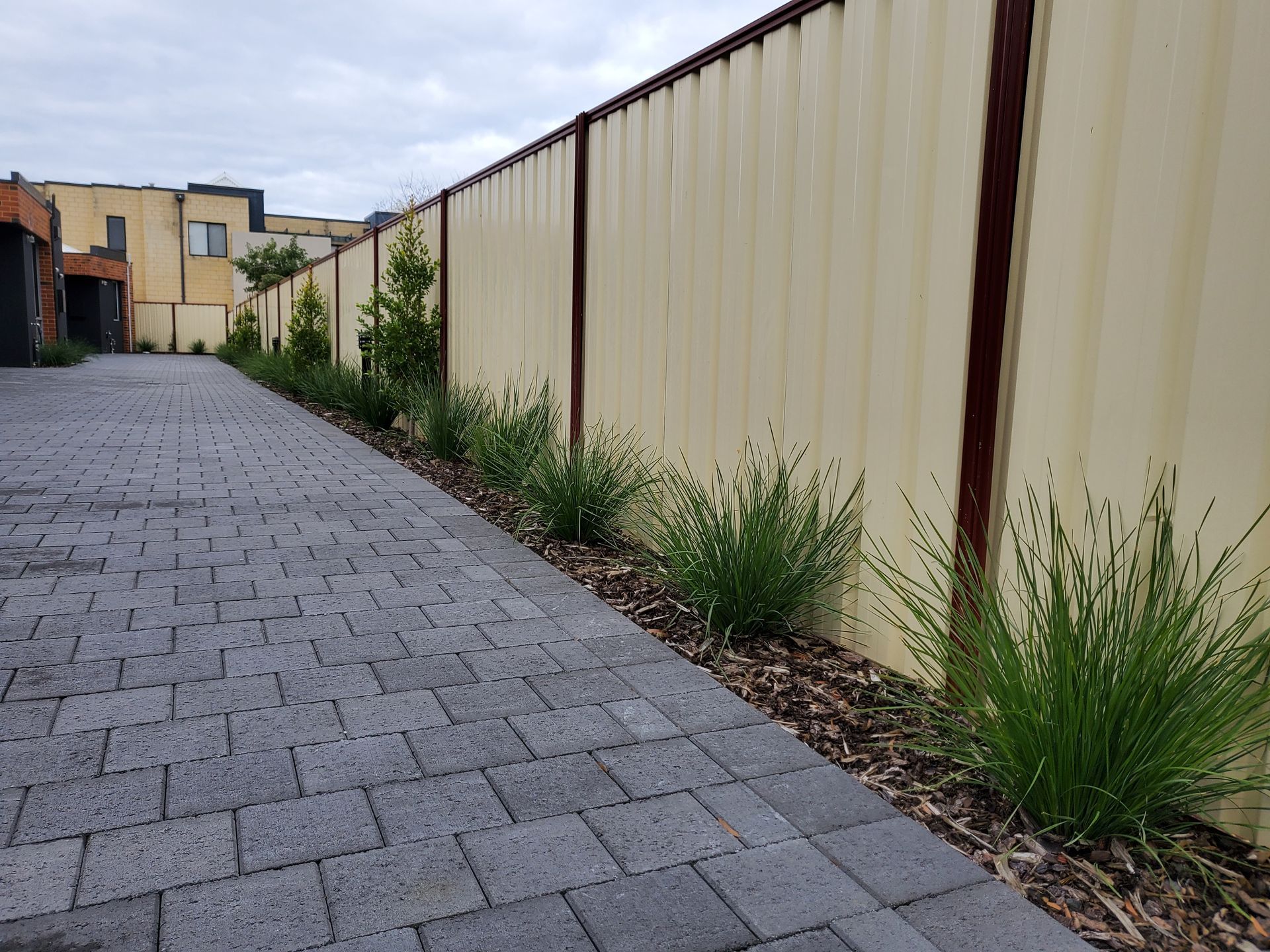 Perth Driveway Strip Installation with waterwise retic design, quality soil and hardy low maintenance native plantings