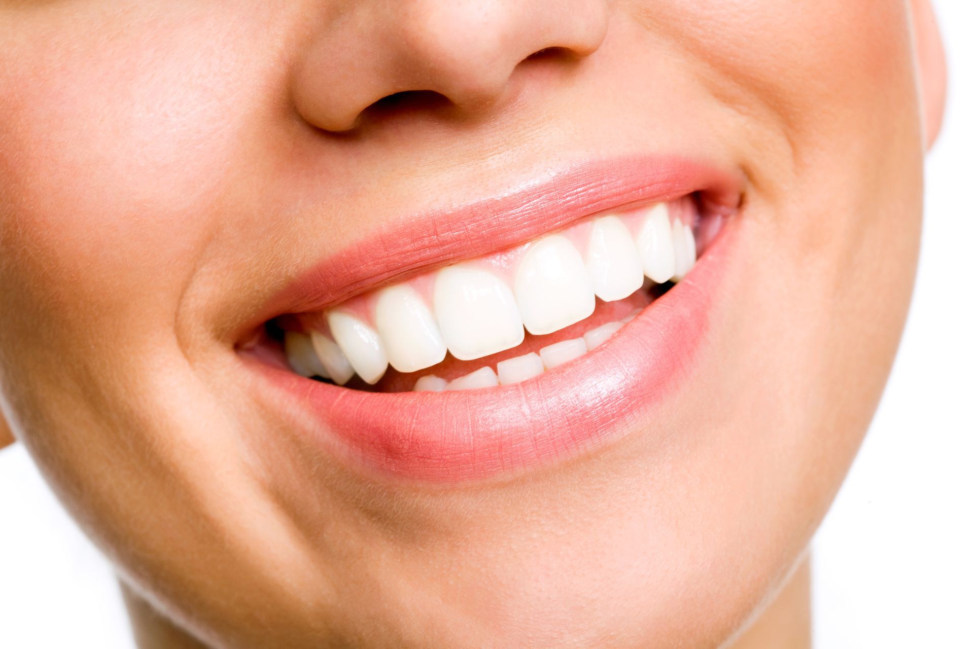 Smiling young woman with white teeth showcasing cosmetic dental services for a brighter smile.