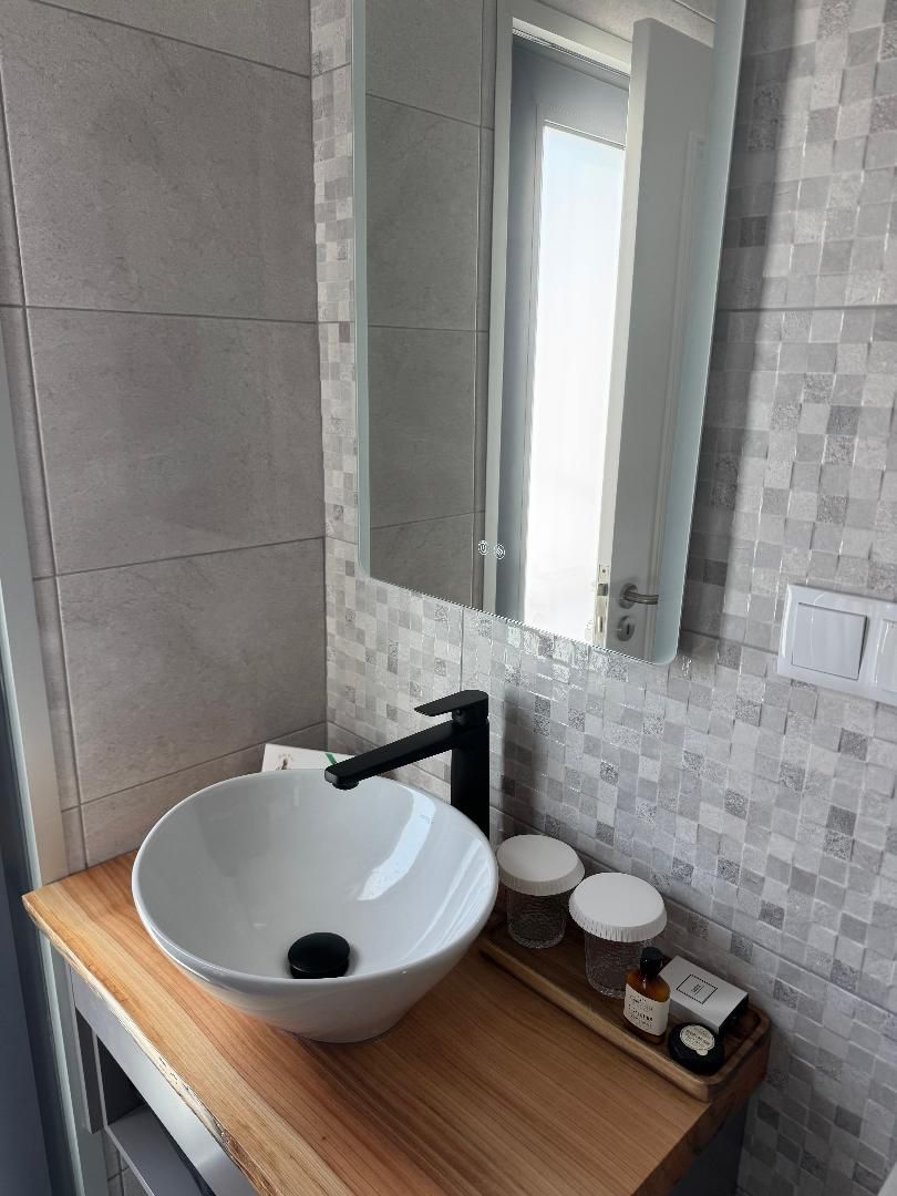 Bathroom with light up mirror and sink