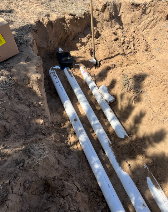 A man is opening the lid of a septic tank.
