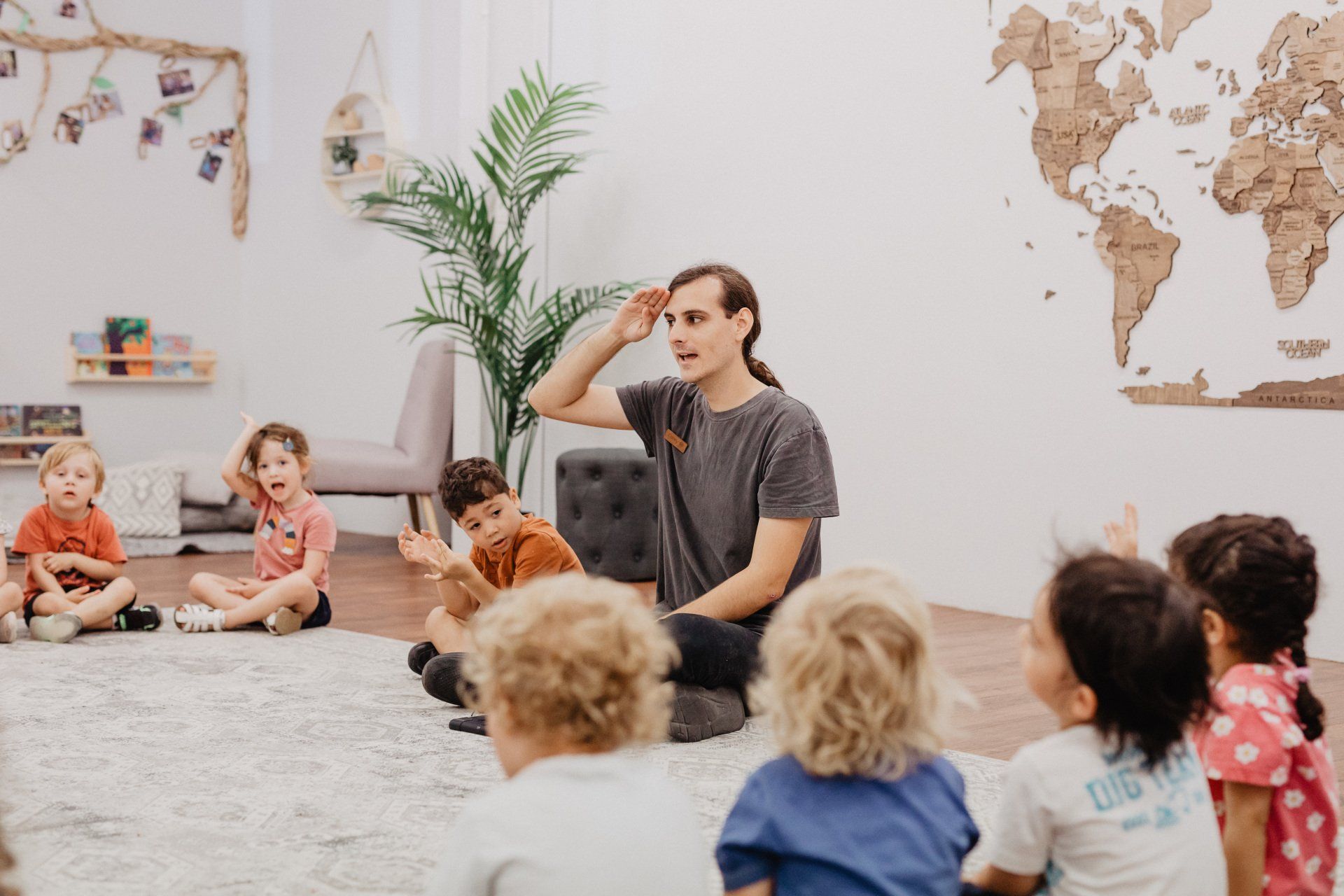 A man interacts with a group of children, promoting fun and educational at Sagewood.
