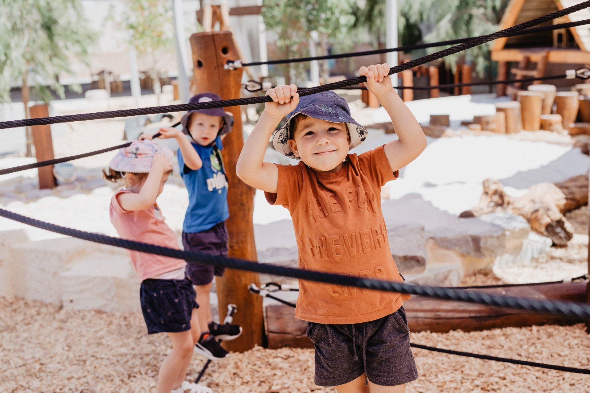 Kids joyfully climbing ropes at Sagewood Joondalup Campus Childcare Centre, enjoying a fun day.