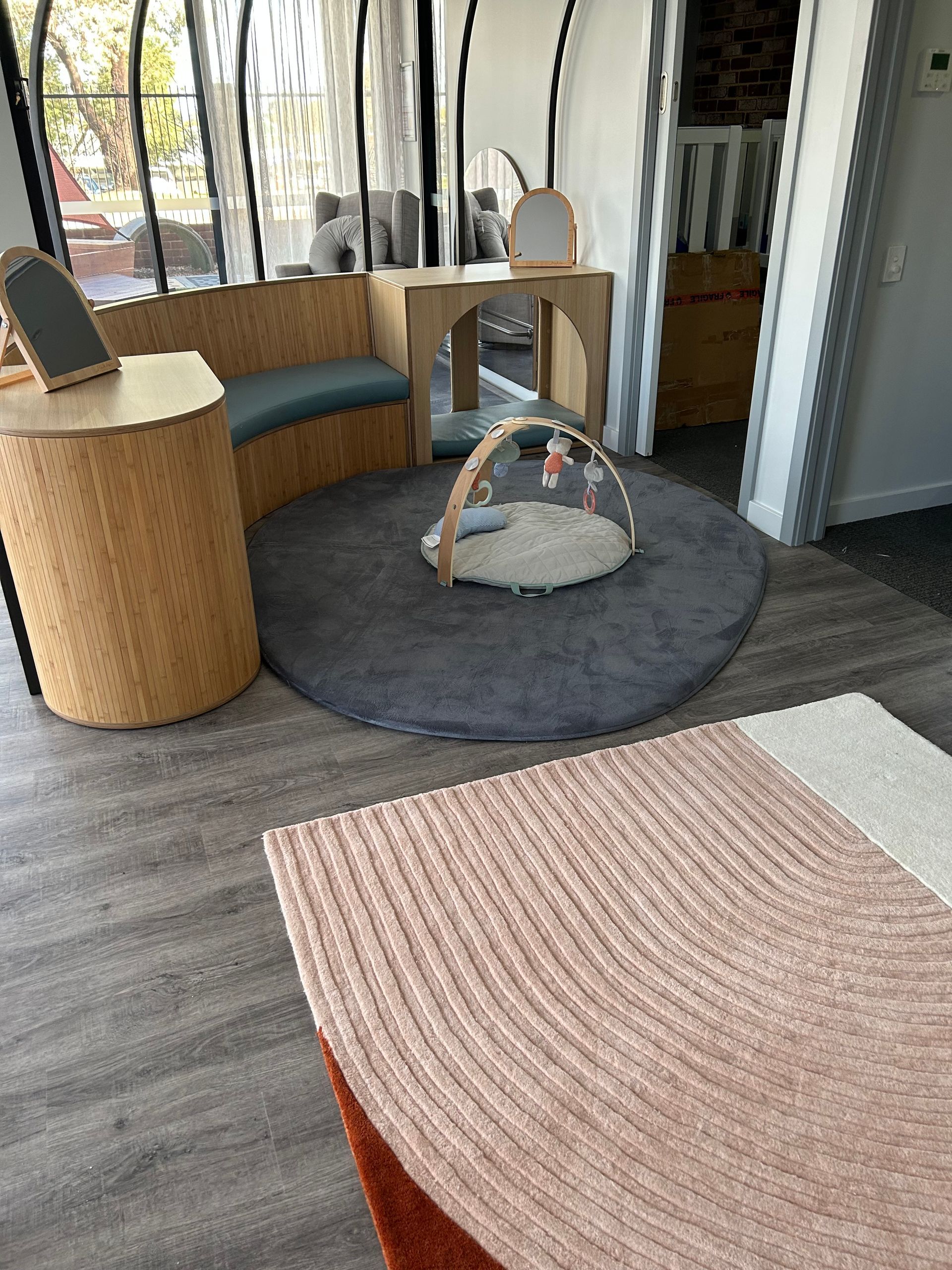 Play area at Sagewood Woodvale Campus with a round table and a chair, perfect for children's activities and fun.