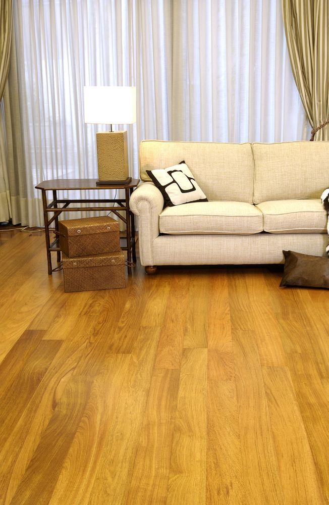 A Living Room With a Couch, Table, Lamp and Wooden Floor — Cairns Floors and More In Redlynch, QLD