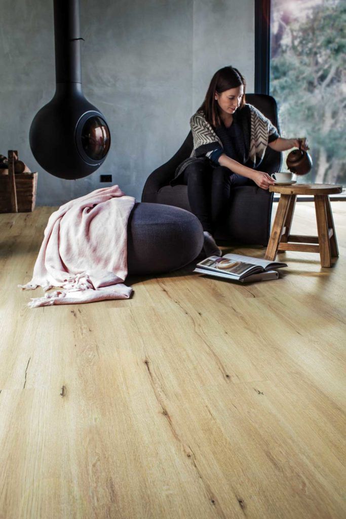 Luxury Vinyl Plank Flooring With Woman Drinking Coffee — Cairns Floors and More In Bungalow, QLD