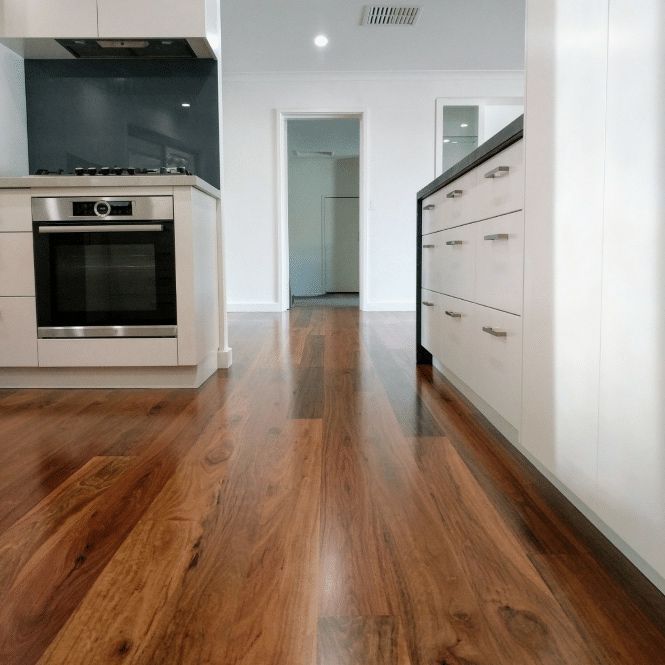 Reflective Timber Flooring With White Cabinets — Cairns Floors and More In Bungalow, QLD