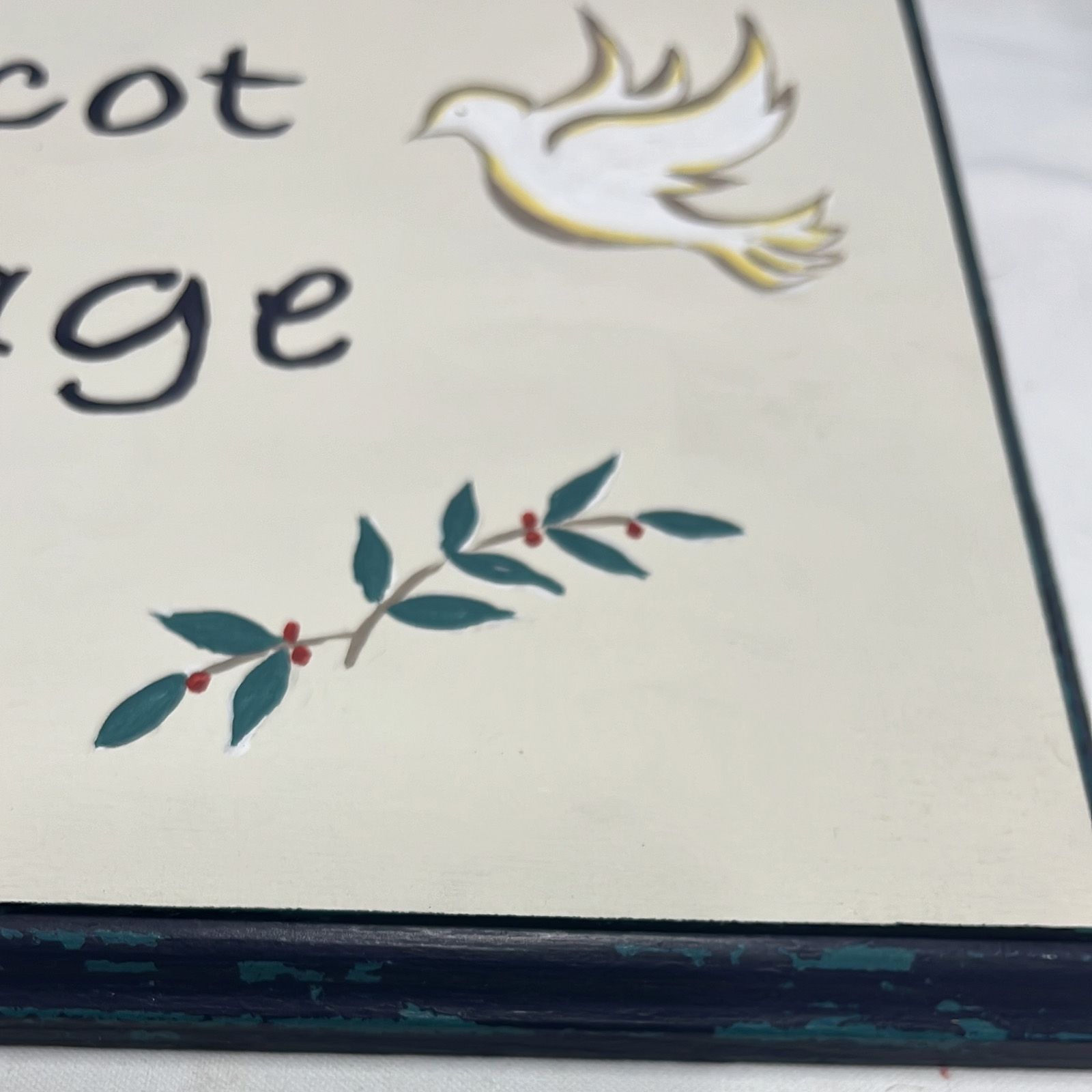 Handpainted olive branch and dove on a bespoke cottage sign.