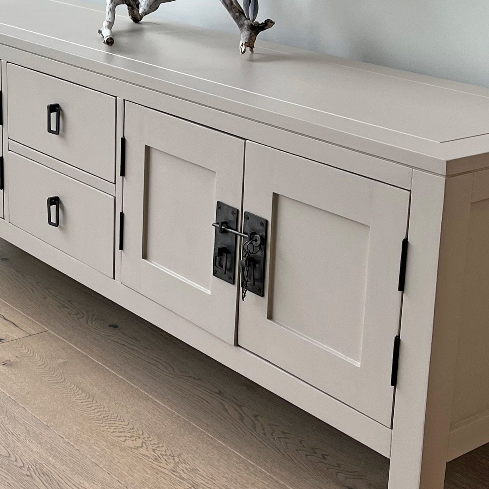 Detail of ironmongery in steel with black hinges.