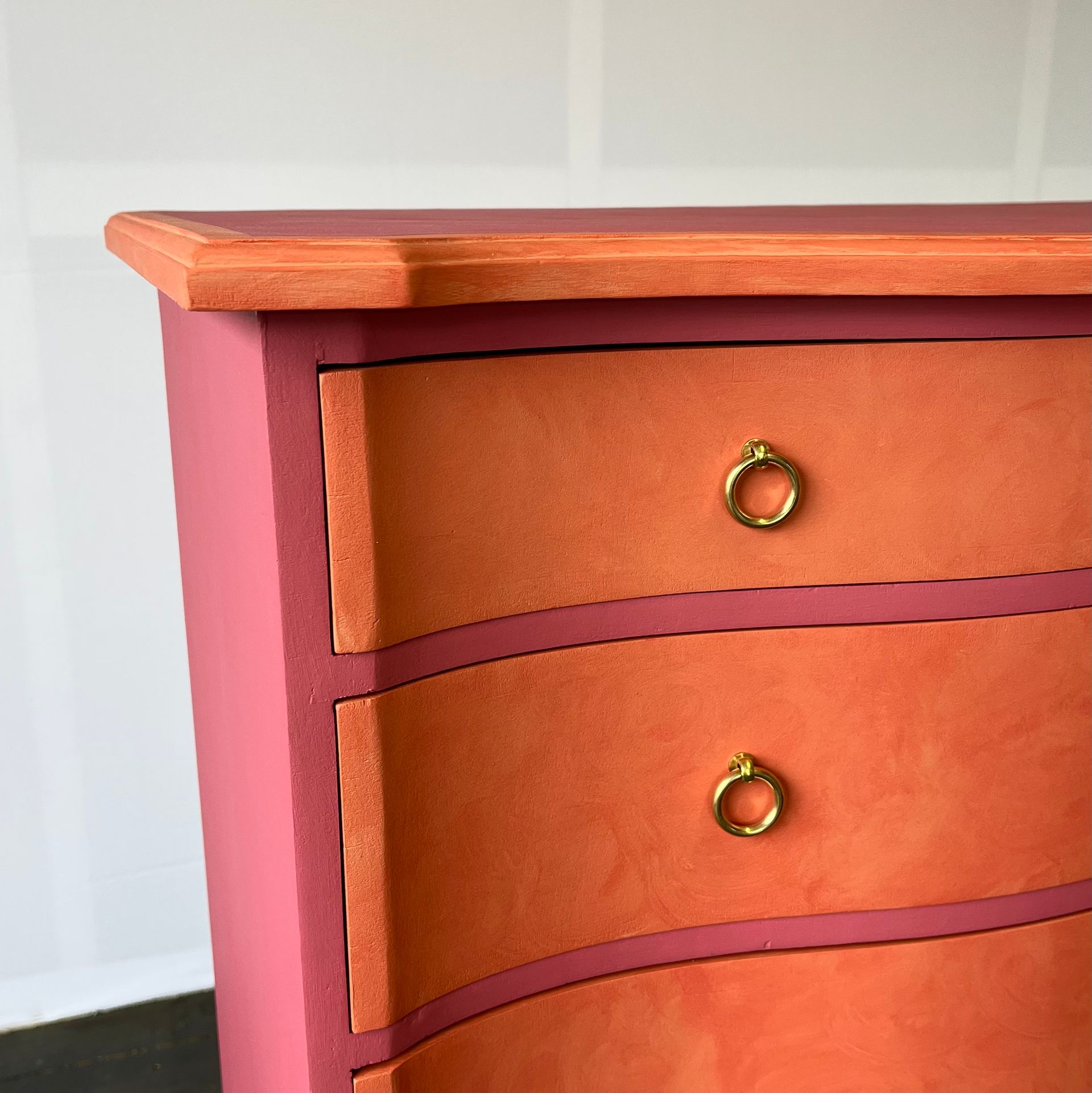 New modern brass pull handles on upcycled Persian rose pink drawers.
