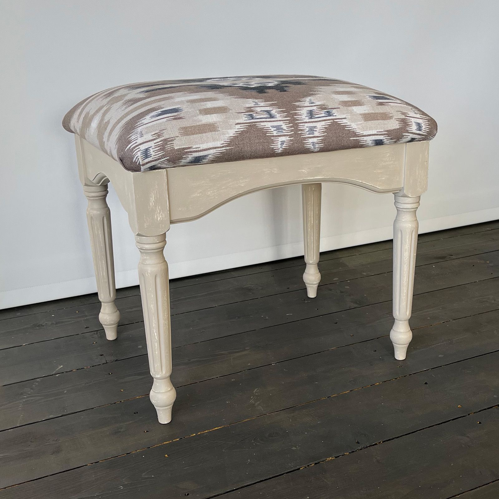 Repro stool upcycled in royal circus beige with new fabric on pad.