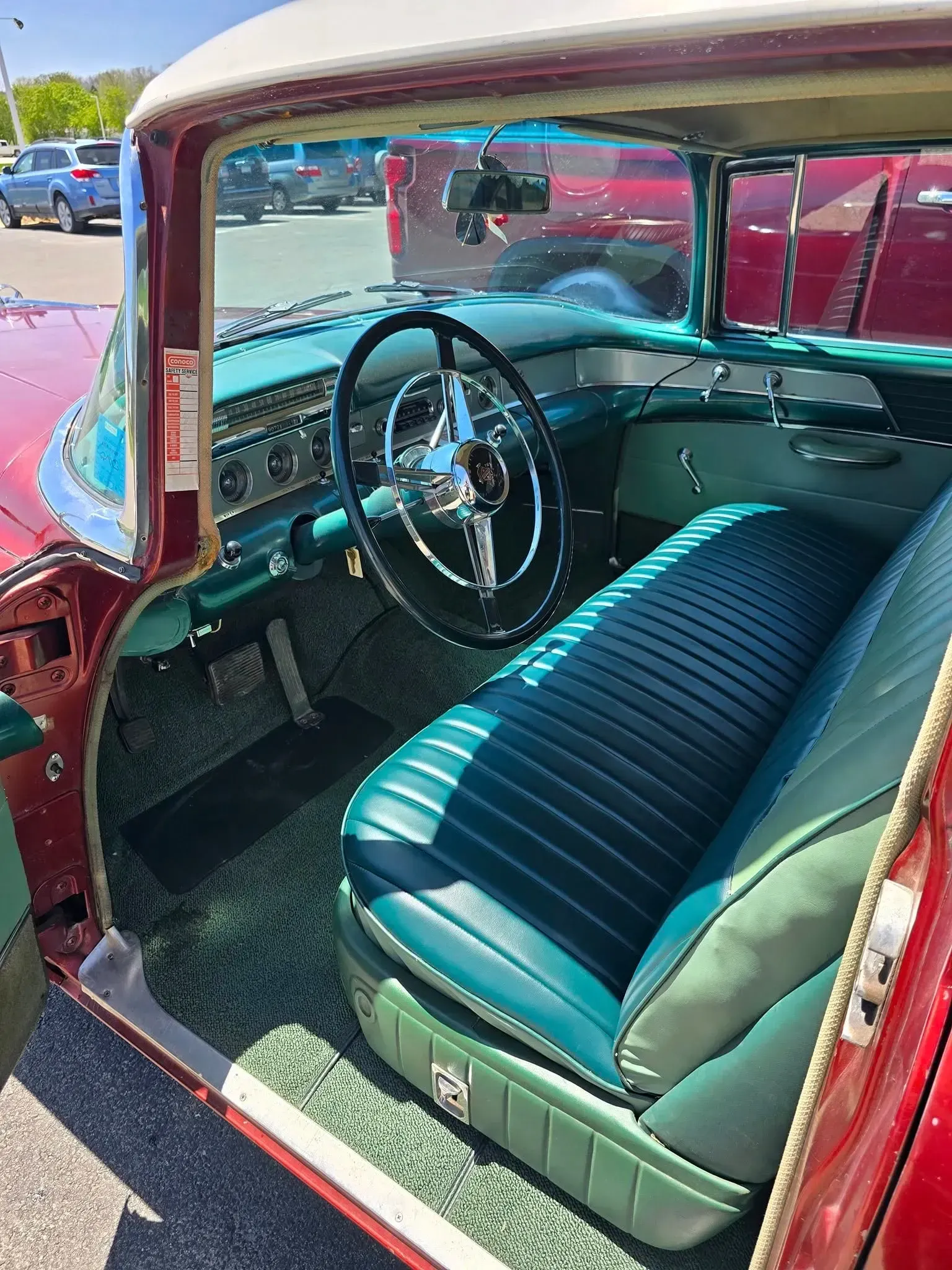 Interior of a Classic Maroon Car With Teal and Green Seating | Steve's Auto Care, Inc.