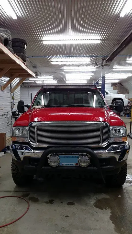 Red Ford Truck With a Black Grill and Bull Bar | Steve's Auto Care, Inc.