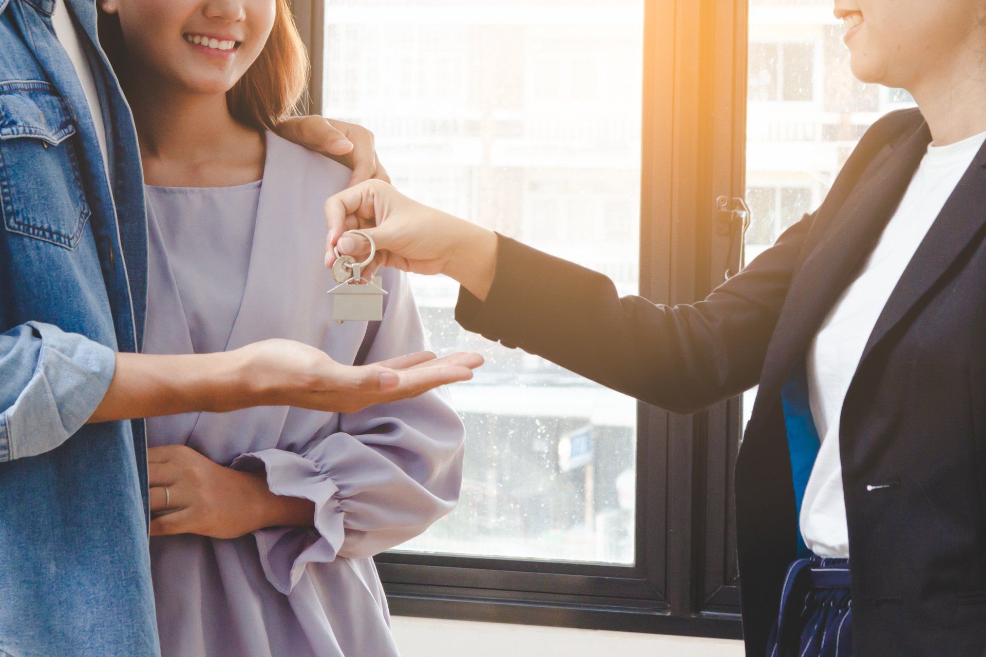 Woman giving a couple some keys