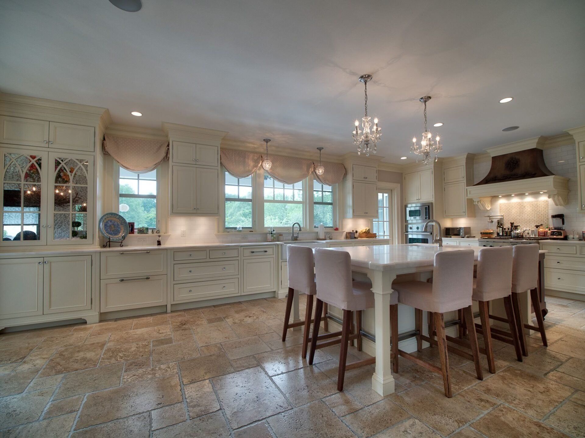 A large kitchen with white cabinets and a large island