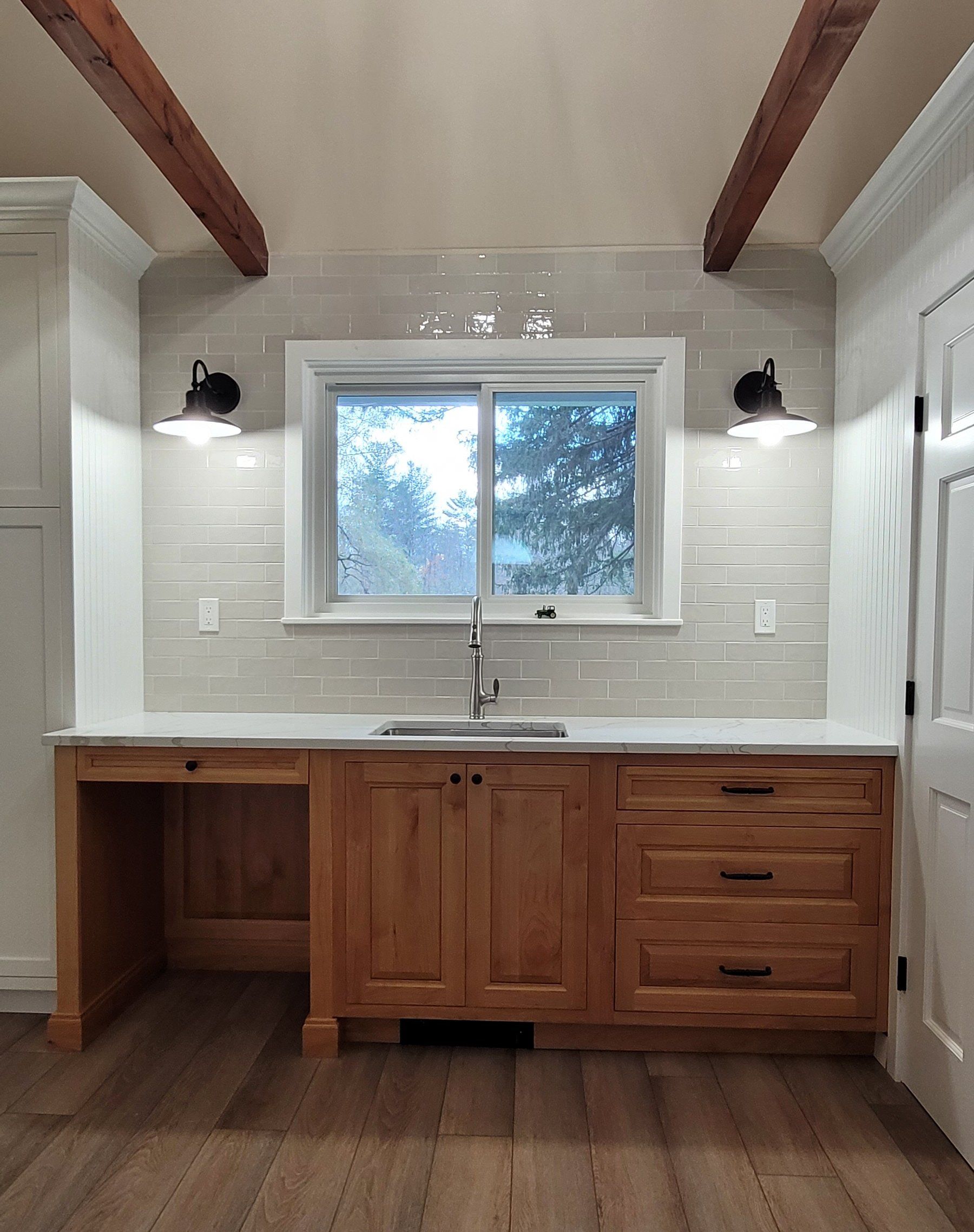 A kitchen with wooden cabinets a sink and a window