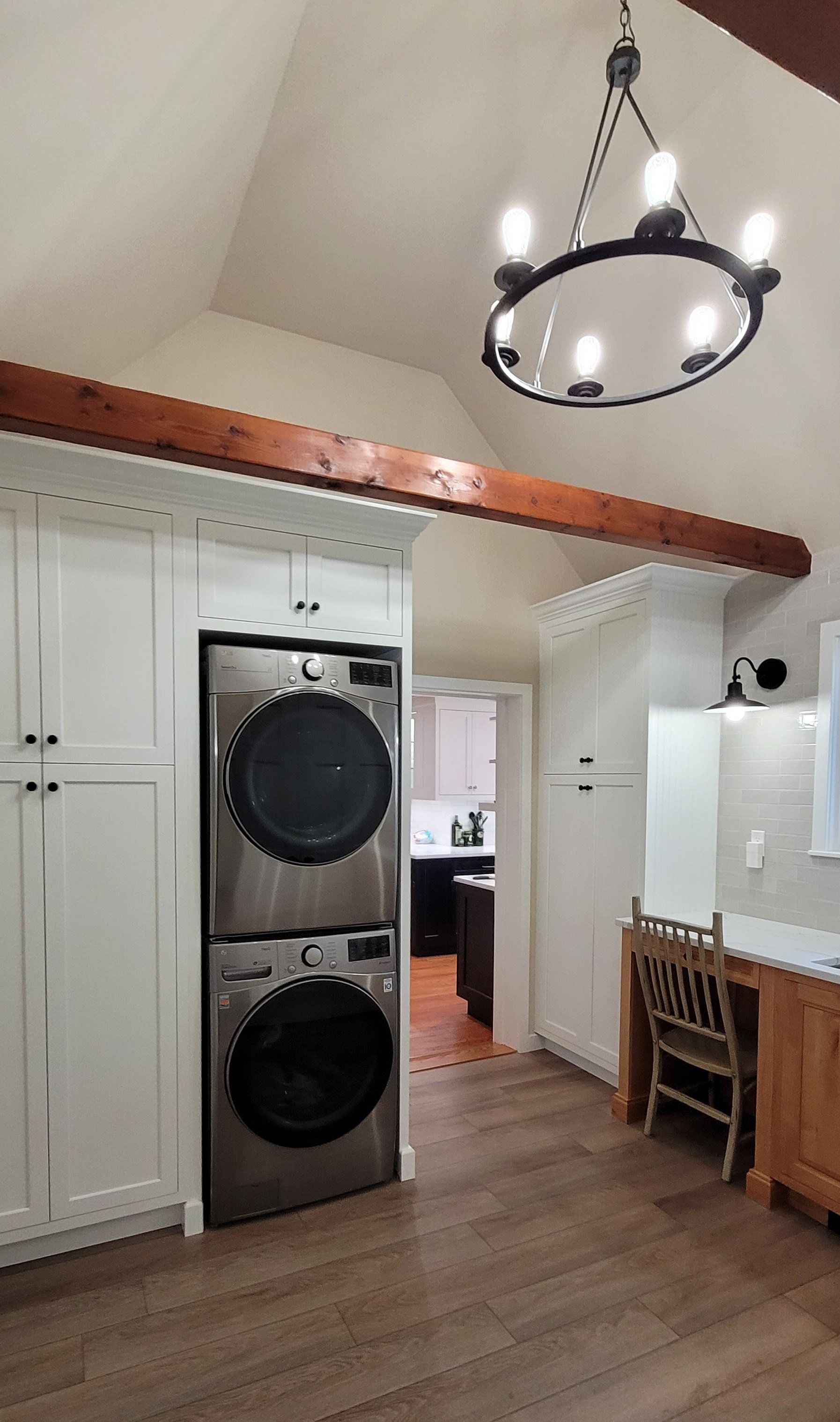 A laundry room with a washer and dryer stacked on top of each other.