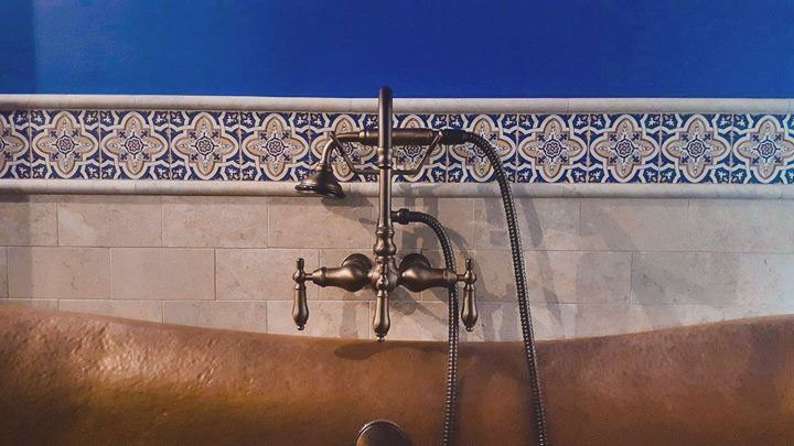 A bathtub with a faucet attached to it