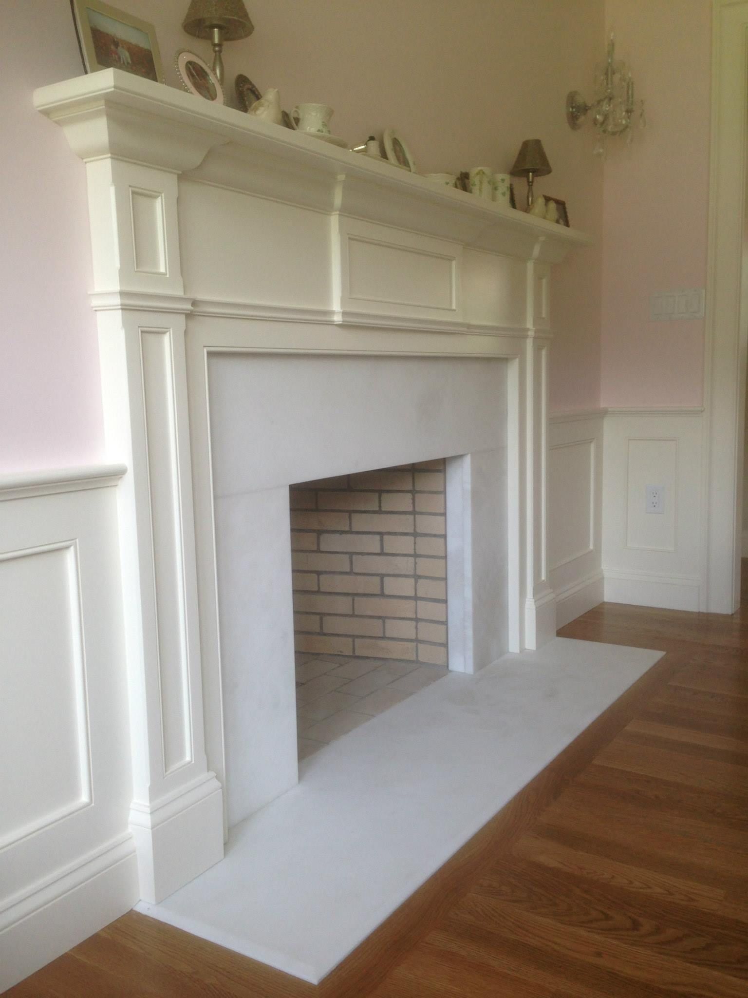 A living room with a fireplace and a wooden floor
