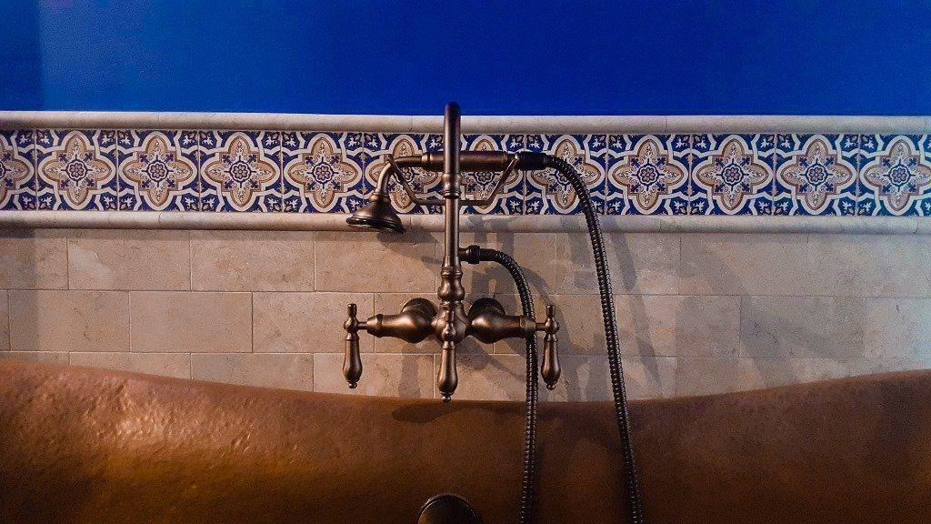 A bathtub with a faucet attached to it