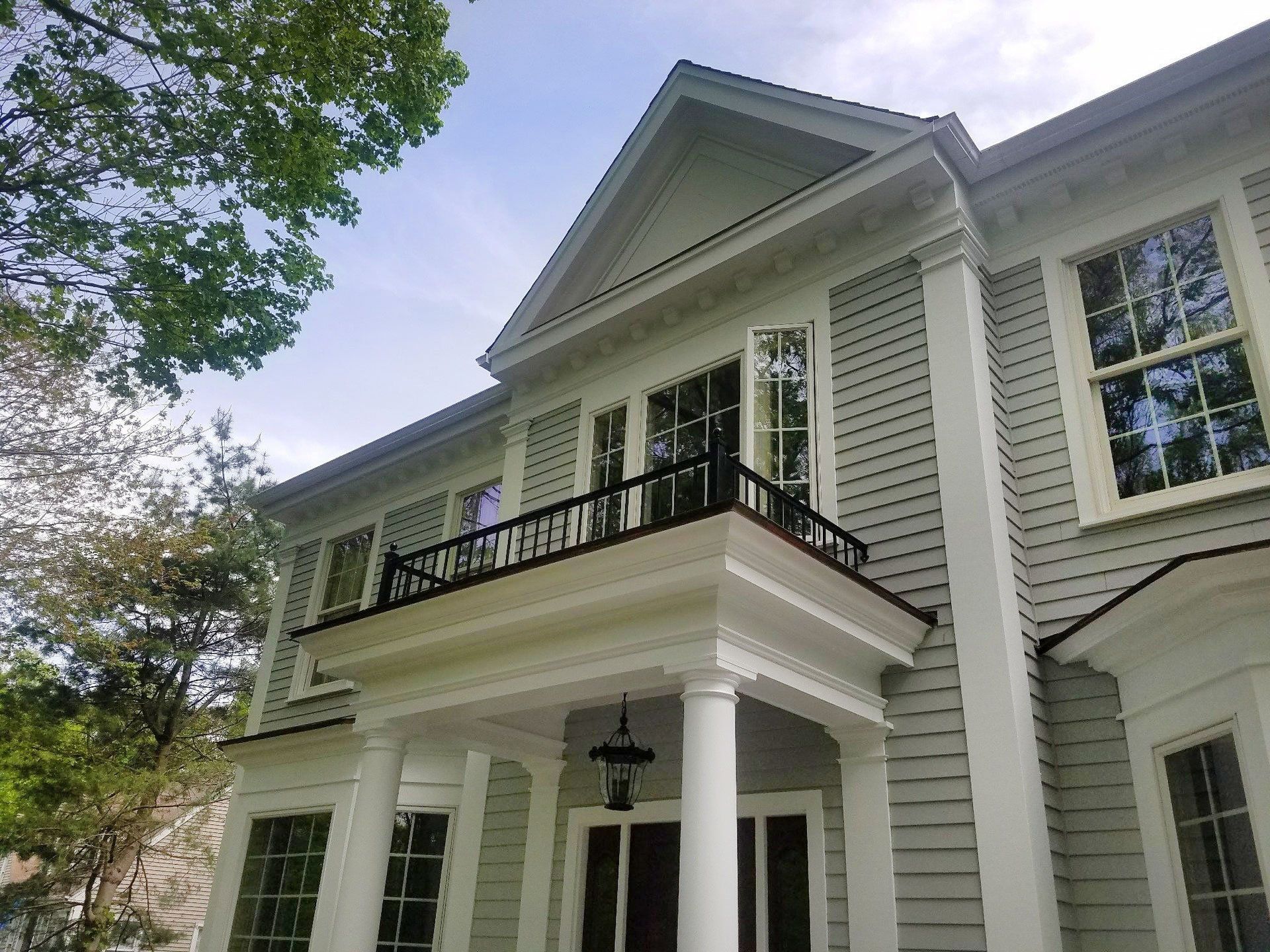 A large white house with a balcony and columns