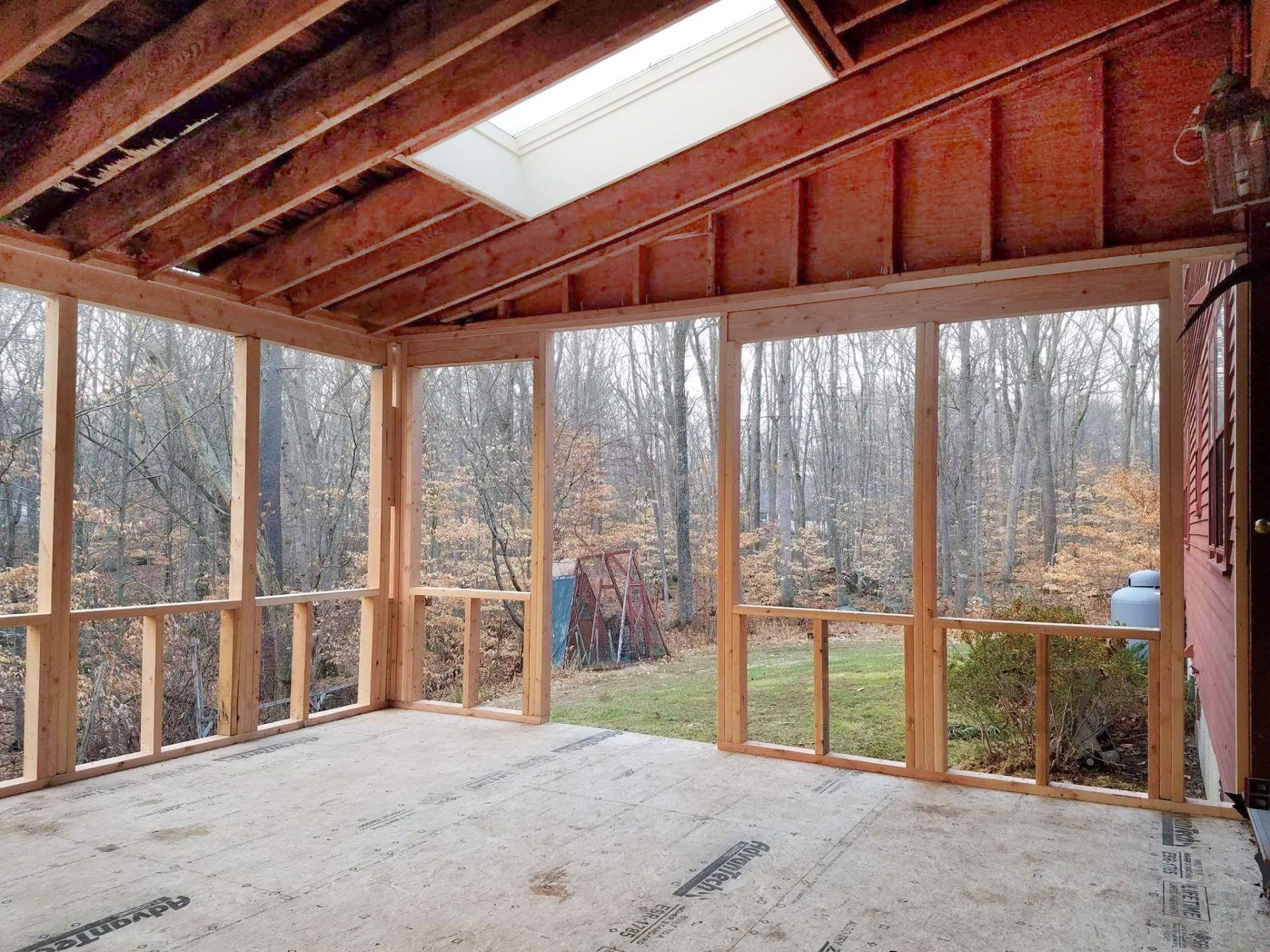 A screened in porch with a skylight in the ceiling