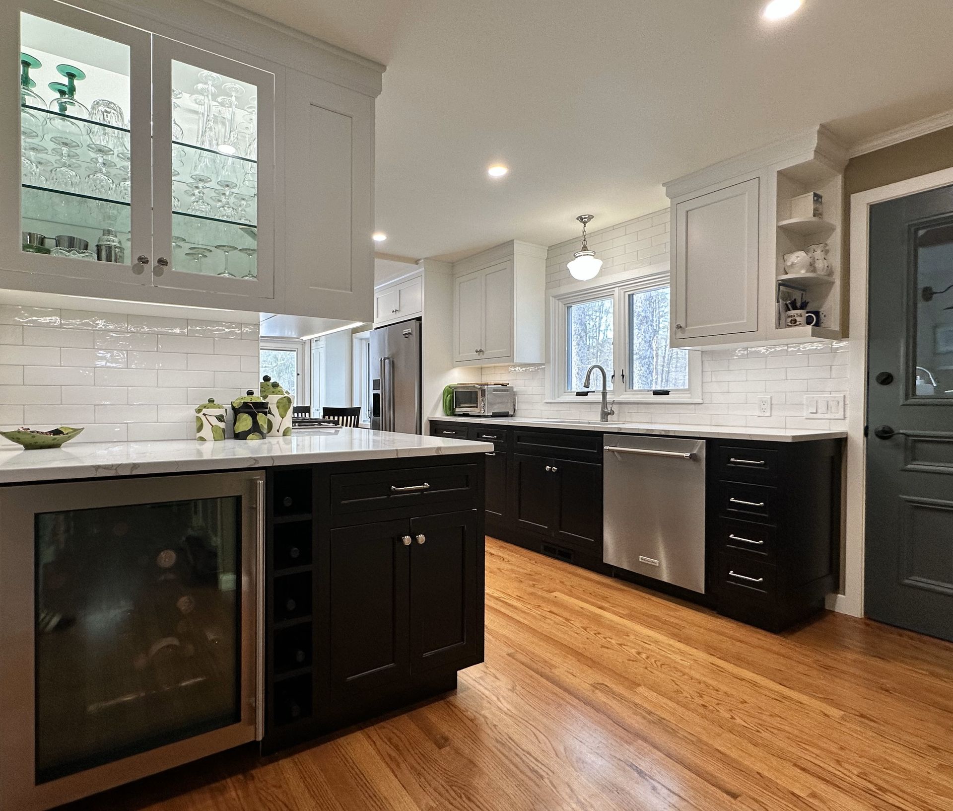 A kitchen with black cabinets and stainless steel appliances
