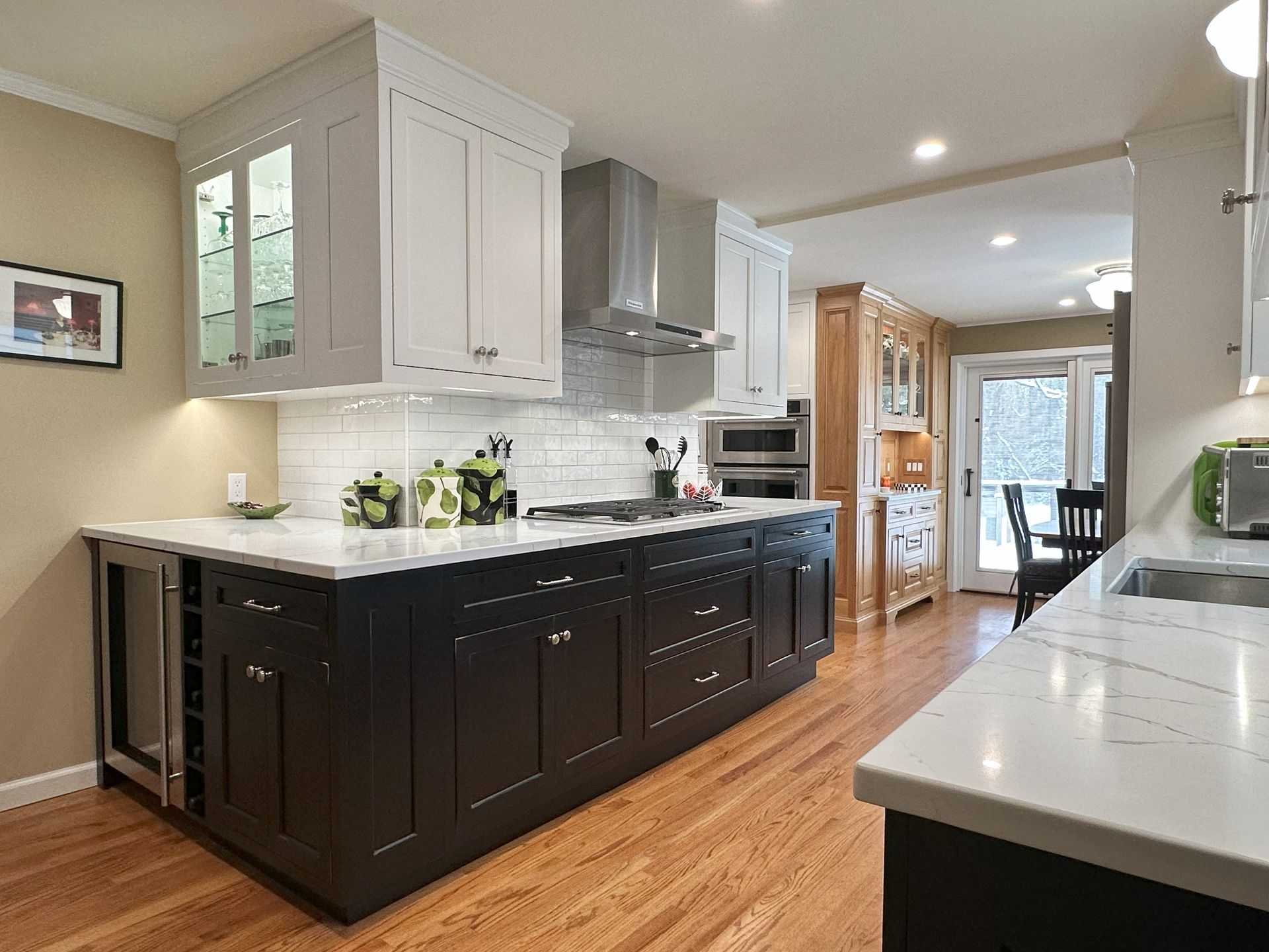 A kitchen with black cabinets and white counter tops
