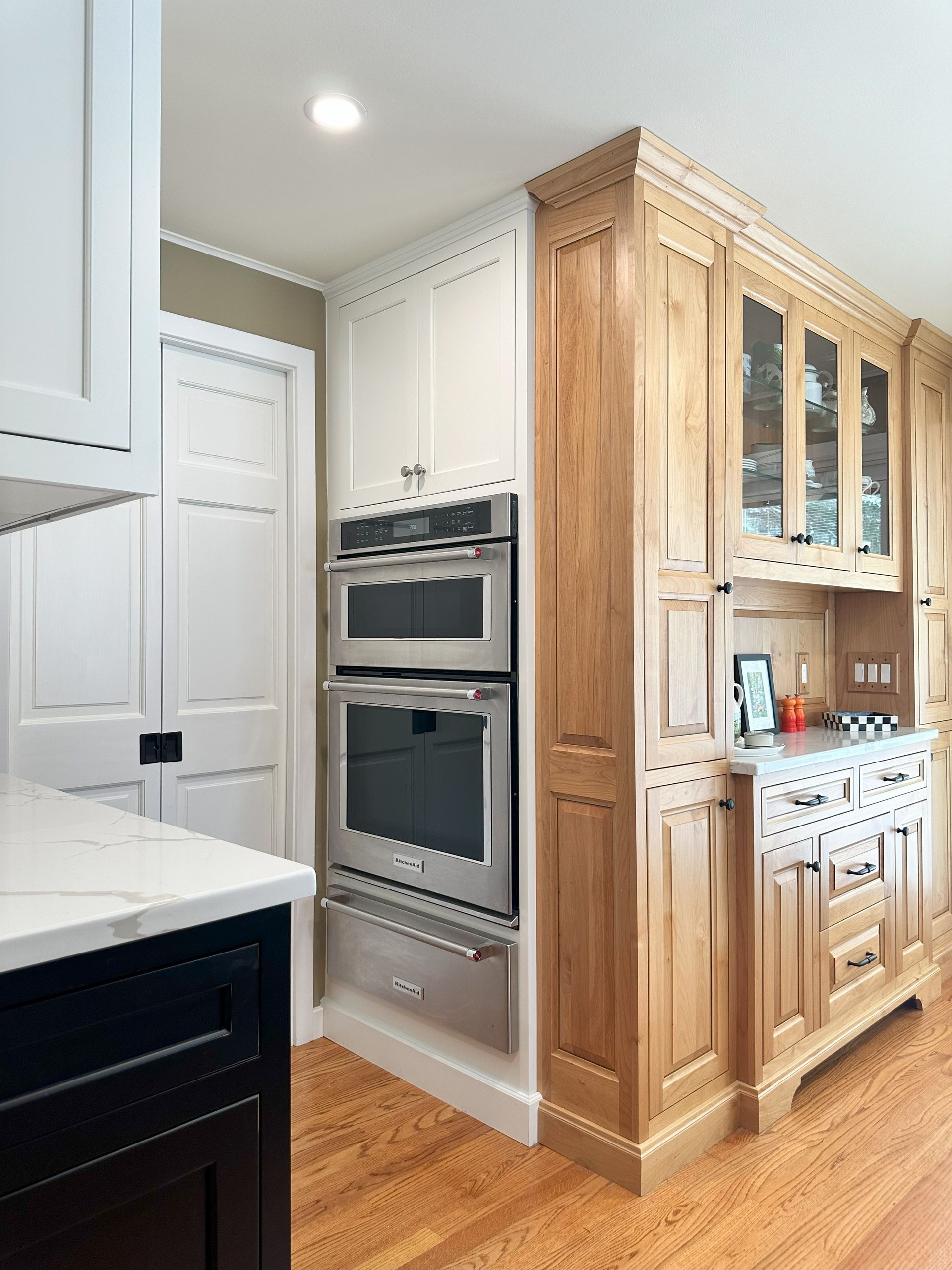 A kitchen with stainless steel appliances and wooden cabinets